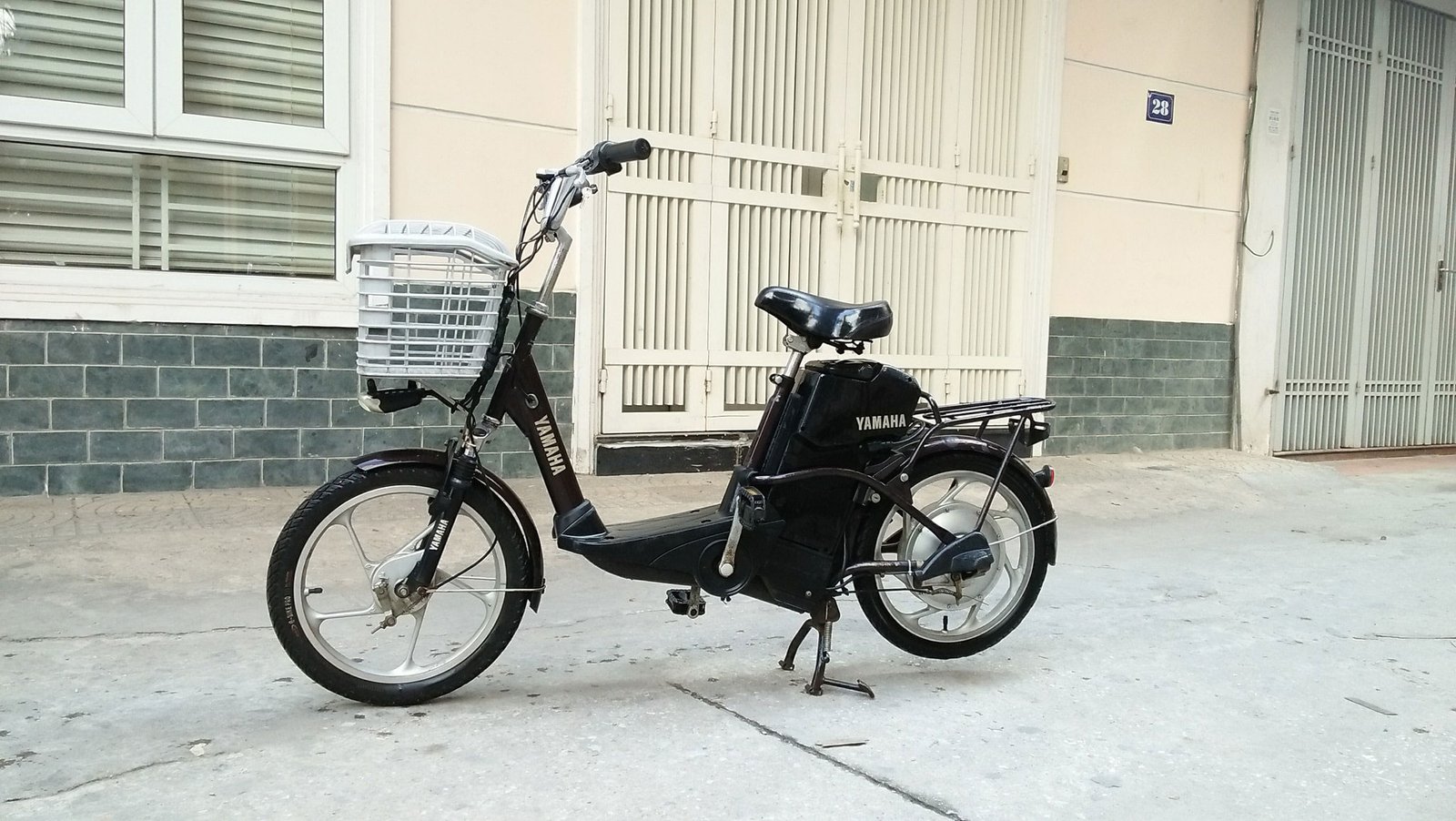 Hình ảnh cận cảnh kiểm tra vành và lốp xe đạp điện cũ