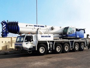 Hình ảnh một chiếc xe cẩu tự hành màu vàng đang hoạt động tại công trường xây dựng ở Thái Bình