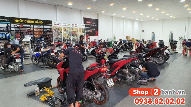 Kỹ thuật viên đang tiến hành bảo dưỡng xe máy trong một garage sạch sẽ