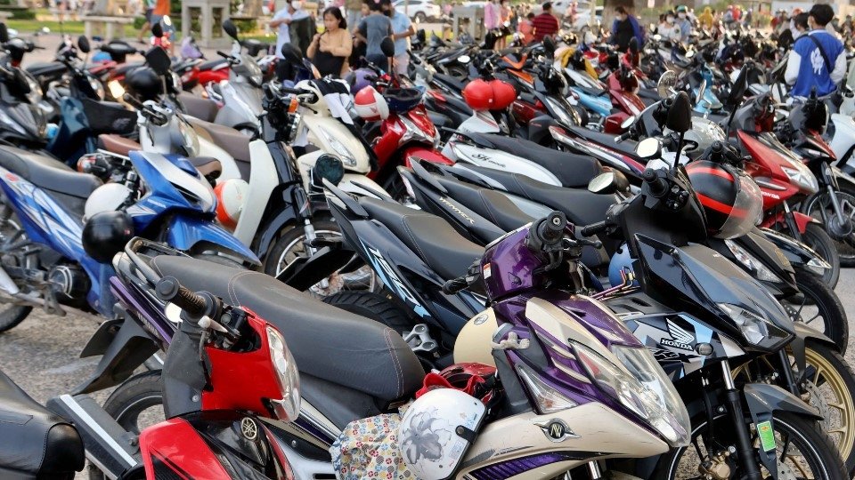 Một chiếc xe máy được đặt gọn gàng trong bãi đỗ có tổ chức